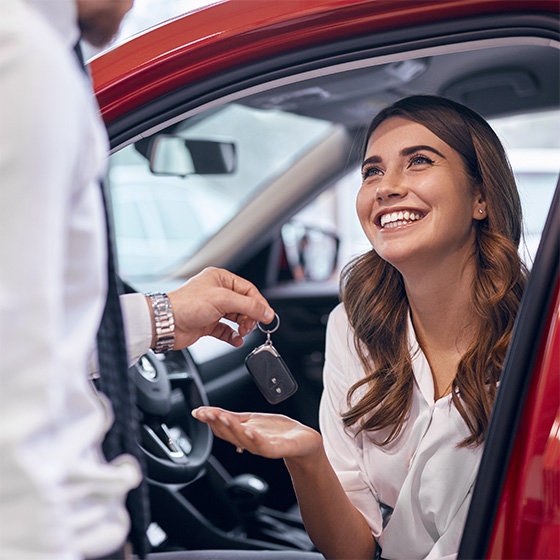 Dealer giving keys to happy customer