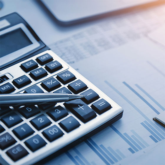 Pen and calculator on table